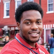 Smiling man with short dark hair and facial hair